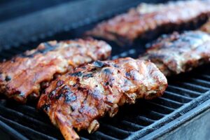 Ribs glistening on barbecue