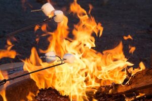 Marshmallows being toasted over a campfire